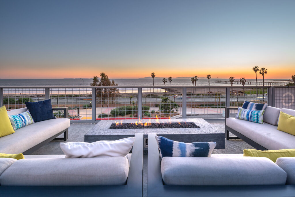 Community fire pit with surrounding plush furniture with views overlooking the ocean
